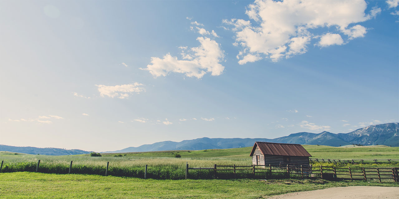 Farm building and fence in a distant field