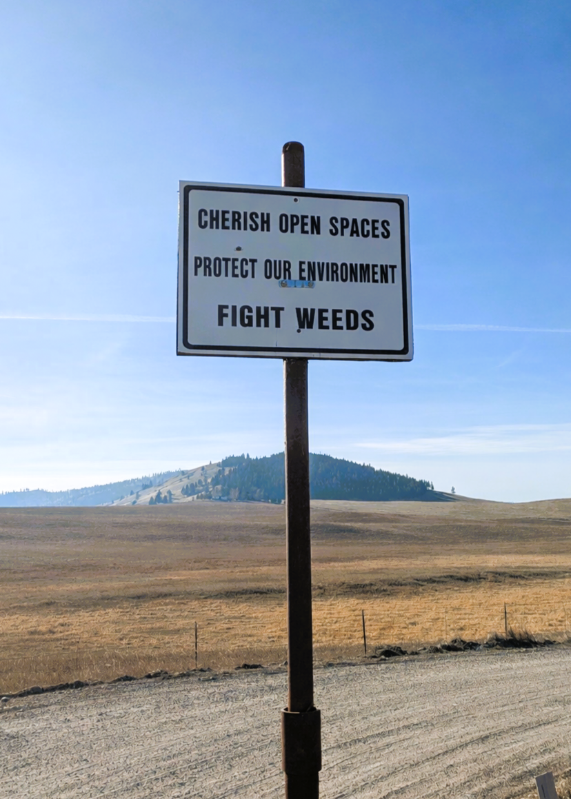 Sign reading "Cherish open spaces, protect our environment, fight weeds."
